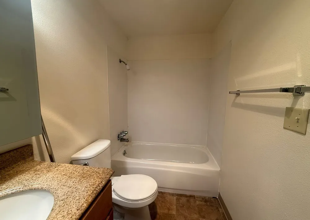 Clean bathroom with a wiped vanity and polished fittings